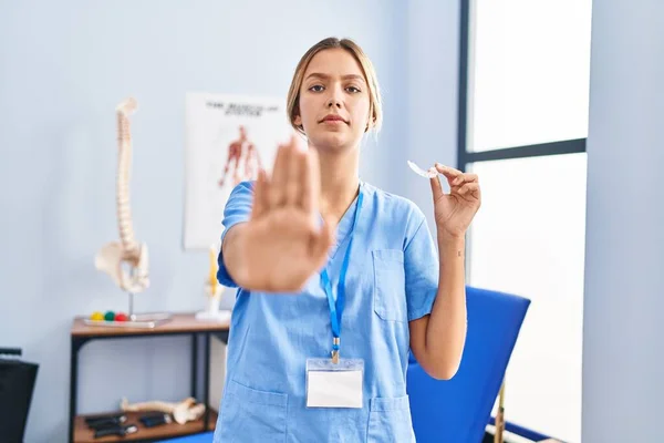 Young Blonde Woman Holding Plastic Aligner Bruxism Open Hand Doing — ストック写真