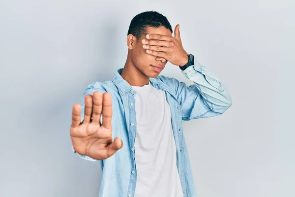Young African American Guy Wearing Casual Clothes Covering Eyes Hands — Stock Photo, Image