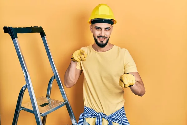 Handsome Man Beard Construction Stairs Wearing Hardhat Pointing Fingers Camera — 스톡 사진