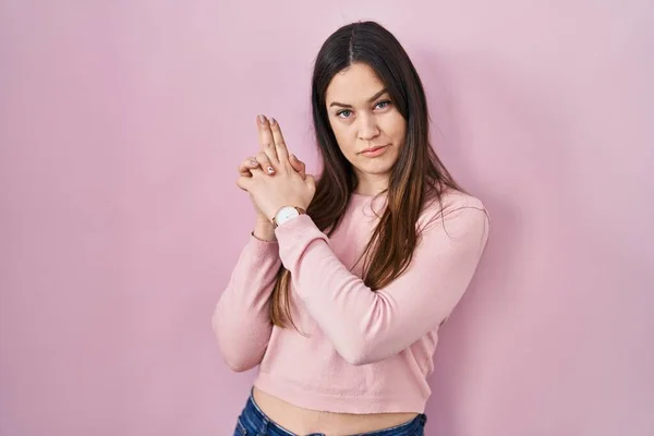 Young Brunette Woman Standing Pink Background Holding Symbolic Gun Hand — Stock Photo, Image