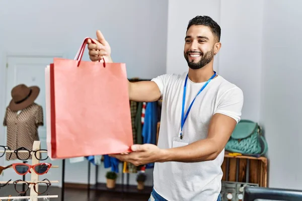 Young Arab Man Shopkeeper Holding Shopping Bags Working Clothing Store — Stock Photo, Image