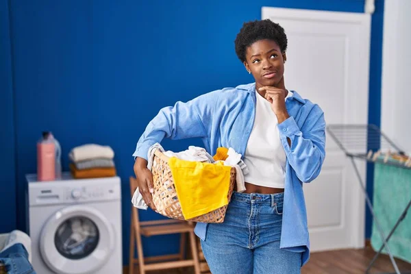 Afrikansk Amerikansk Kvinna Håller Tvättkorg Allvarligt Ansikte Tänker Fråga Med — Stockfoto