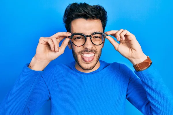 Young Hispanic Man Wearing Glasses Sticking Tongue Out Happy Funny — Stock Photo, Image