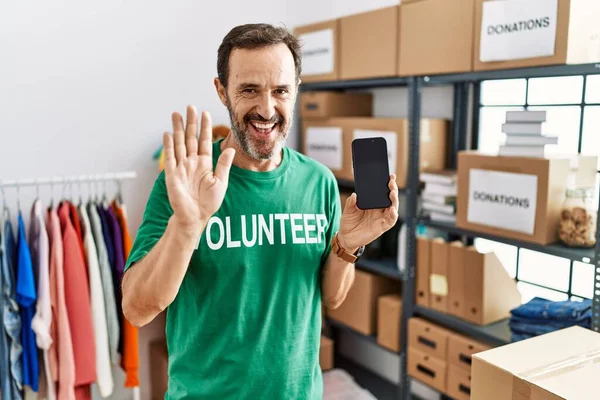 Middle Age Man Beard Wearing Volunteer Shirt Holding Smartphone Waiving — Stok fotoğraf