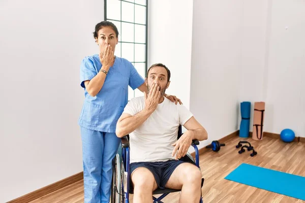 Hispanic Middle Age Man Sitting Wheelchair Nurse Rehabilitation Clinic Covering — Zdjęcie stockowe