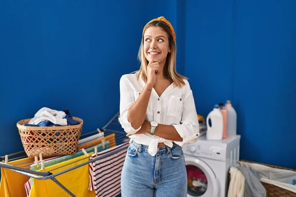 Young Blonde Woman Laundry Room Hand Chin Thinking Question Pensive — Fotografia de Stock