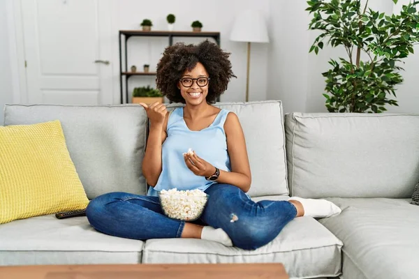 Africano Americano Mulher Com Cabelo Afro Sentado Sofá Comer Pipocas — Fotografia de Stock