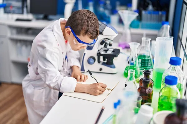 Blond Child Wearing Scientist Uniform Writing Notebook Laboratory — Zdjęcie stockowe