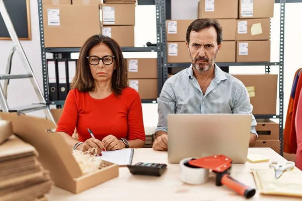 Middle Age Couple Working Small Business Ecommerce Skeptic Nervous Frowning —  Fotos de Stock