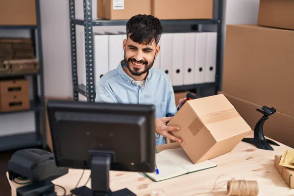 Young Hispanic Man Ecommerce Business Worker Scanning Package Office — стоковое фото
