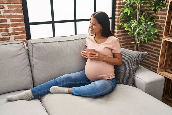 Young Latin Woman Pregnant Drinking Coffee Sitting Sofa Home — Foto de Stock
