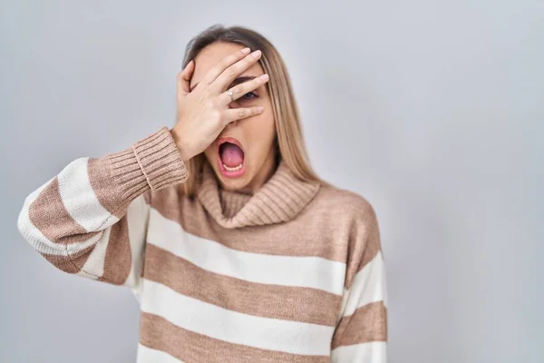Young Blonde Woman Wearing Turtleneck Sweater Isolated Background Peeking Shock — Stock Photo, Image