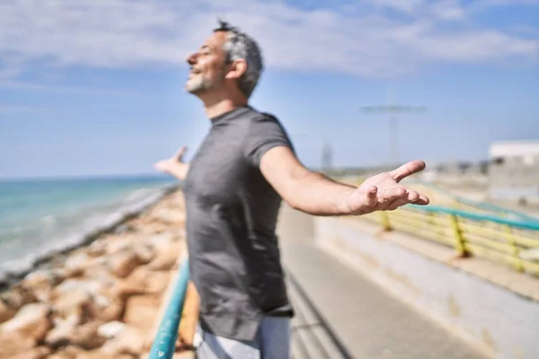 Middle Age Hispanic Man Wearing Sportswear Breathing Seaside — Stock Photo, Image