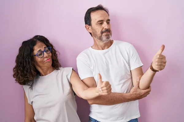 Middle Age Hispanic Couple Together Pink Background Looking Proud Smiling — Fotografia de Stock