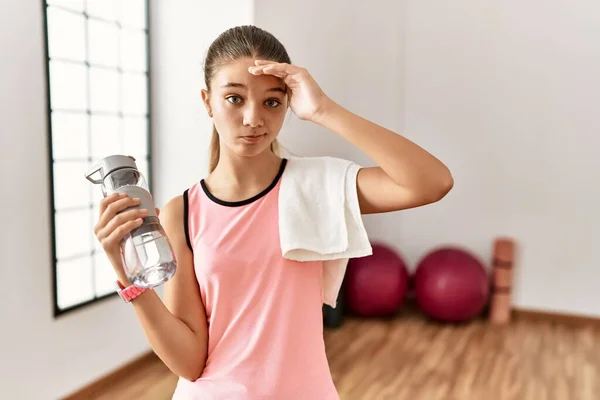 Young Brunette Teenager Wearing Sportswear Holding Water Bottle Worried Stressed — Fotografia de Stock