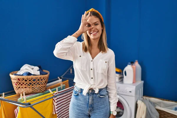 Young Blonde Woman Laundry Room Doing Gesture Hand Smiling Eye — Stockfoto