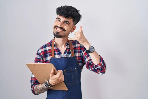 Young Hispanic Man Beard Wearing Waiter Apron Holding Clipboard Smiling —  Fotos de Stock