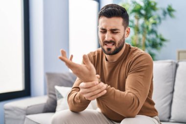 Evdeki kanepede oturan İspanyol bir adam bilek yaralanmasından muzdarip.