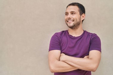 Young man smiling confident standing with arms crossed gesture over white isolated background