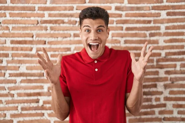 Young Hispanic Man Standing Bricks Wall Celebrating Crazy Amazed Success — Stock Fotó