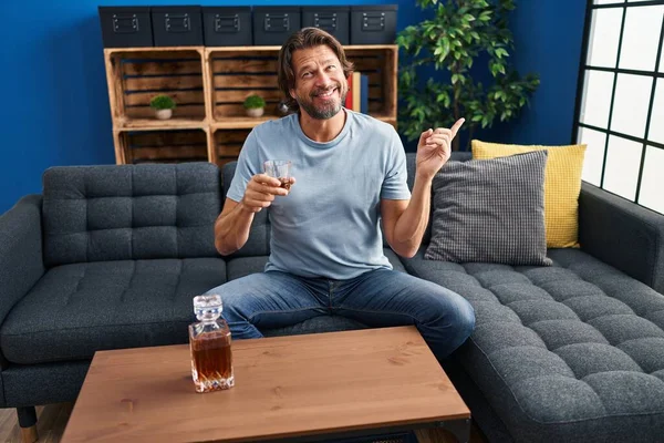 Handsome Middle Age Man Drinking Glass Whiskey Sitting Sofa Smiling — Stockfoto