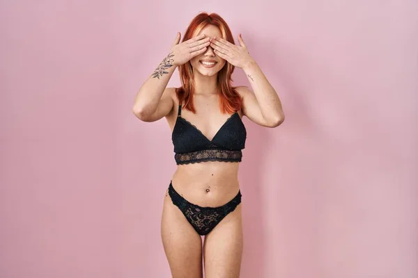 Young Caucasian Woman Wearing Lingerie Pink Background Covering Eyes Hands — Stockfoto