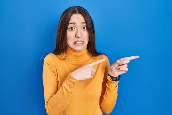 Young Brunette Woman Standing Blue Background Pointing Aside Worried Nervous — Stock Photo, Image