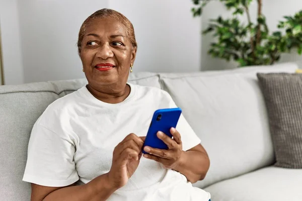 Senior Αφροαμερικανή Γυναίκα Χαμογελά Αυτοπεποίθηση Χρησιμοποιώντας Smartphone Στο Σπίτι — Φωτογραφία Αρχείου