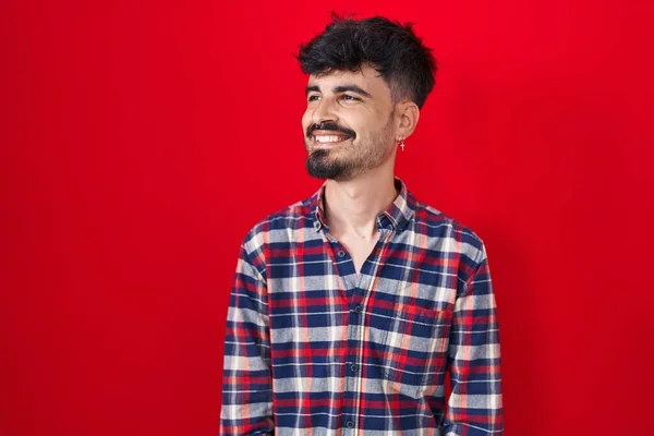Young Hispanic Man Beard Standing Red Background Looking Away Side — Fotografia de Stock