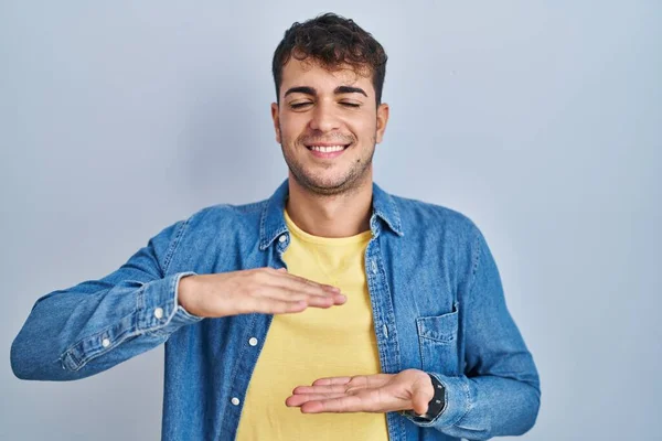 Homem Hispânico Jovem Sobre Fundo Azul Gesto Com Mãos Mostrando — Fotografia de Stock
