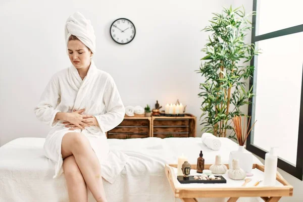 Young Blonde Woman Wearing Bathrobe Wellbeing Spa Hand Stomach Because — Foto Stock