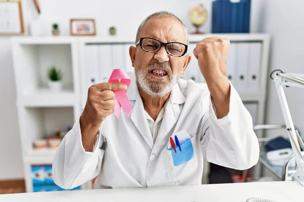 Mature Doctor Man Holding Pink Cancer Ribbon Clinic Annoyed Frustrated — Stockfoto