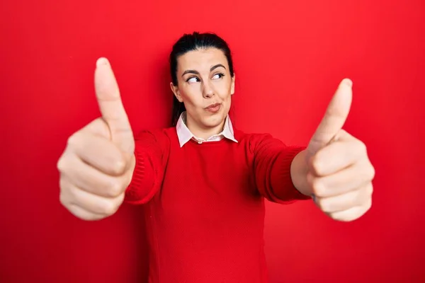 Young Hispanic Woman Doing Thumbs Positive Gesture Smiling Looking Side — Foto Stock