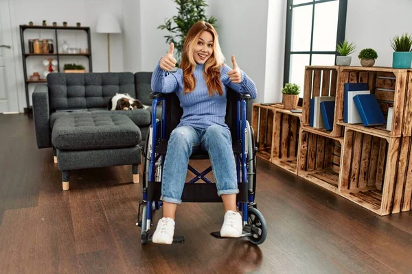 Young Beautiful Woman Sitting Wheelchair Home Approving Doing Positive Gesture — 스톡 사진