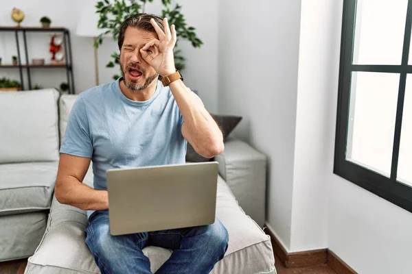 Handsome Middle Age Man Using Computer Laptop Sofa Doing Gesture — Stockfoto