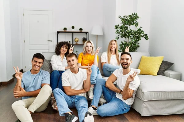 Group People Sitting Sofa Floor Home Smiling Happy Face Winking — Stockfoto