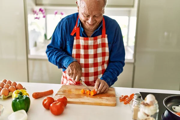 Senior Man Smiling Confident Cutting Carrot Kitchen — Stock Photo, Image