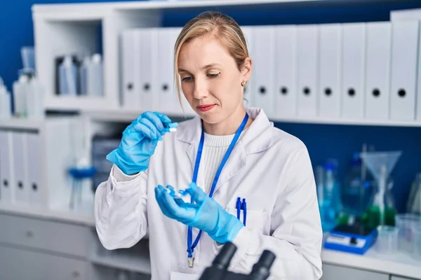 Young Blonde Woman Scientist Holding Pills Laboratory — Stock Photo, Image