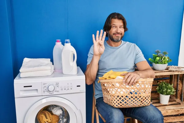 Handsome Middle Age Man Waiting Laundry Showing Pointing Fingers Number —  Fotos de Stock