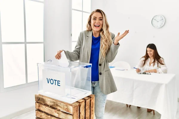 Young Blonde Woman Voting Putting Envelop Ballot Box Celebrating Victory — 스톡 사진