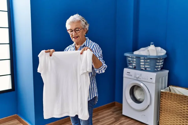Senior Grey Haired Woman Smiling Confident Holding White Shirt Laundry — Stock Photo, Image