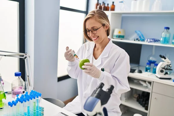 Young Blonde Woman Scientist Injecting Liquid Apple Laboratory — Stock Photo, Image