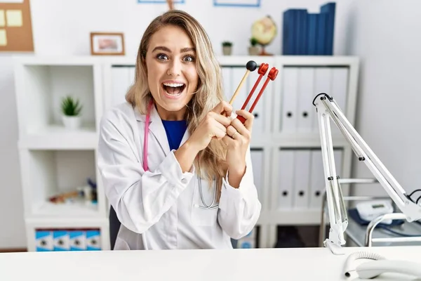 Young Beautiful Doctor Woman Holding Diapason Instrument Celebrating Crazy Amazed — Photo