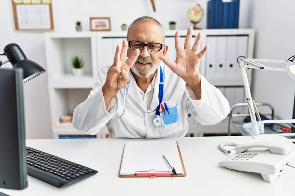 Mature Doctor Man Clinic Showing Pointing Fingers Number Eight While — Stok fotoğraf