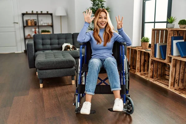 Young Beautiful Woman Sitting Wheelchair Home Showing Pointing Fingers Number — Stock fotografie