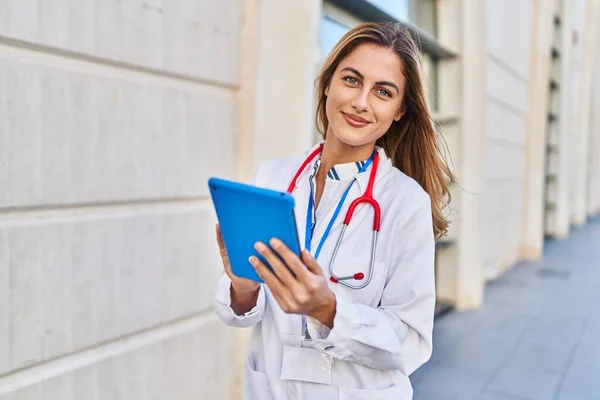 Young Blonde Woman Wearing Doctor Uniform Using Touchpad Hospital — Stockfoto