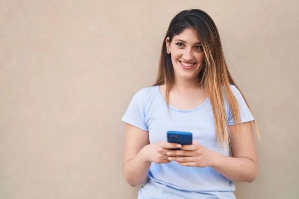 Νεαρή Ισπανόφωνη Γυναίκα Χαμογελά Αυτοπεποίθηση Χρησιμοποιώντας Smartphone Απομονωμένο Λευκό Φόντο — Φωτογραφία Αρχείου