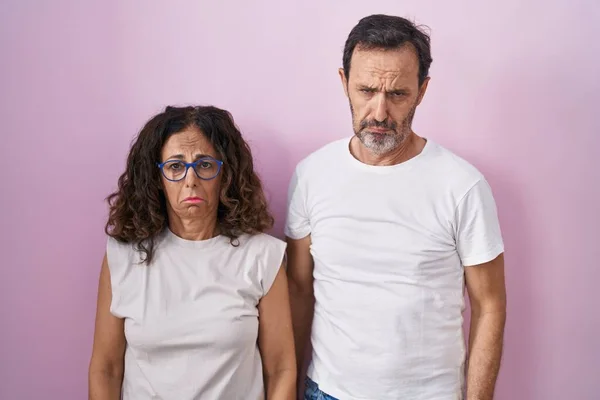 Middle Age Hispanic Couple Together Pink Background Depressed Worry Distress —  Fotos de Stock