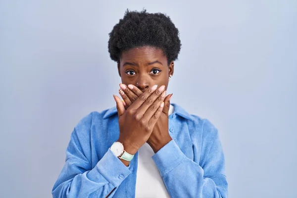 African American Woman Standing Blue Background Shocked Covering Mouth Hands — Stockfoto