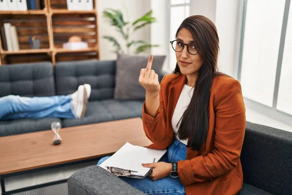 Young Hispanic Woman Working Psychology Counselor Showing Middle Finger Impolite — 스톡 사진